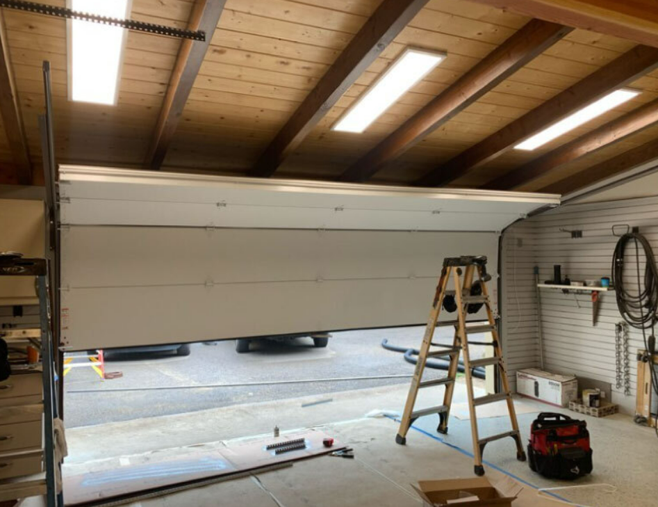 Technician performing garage door repair in Sun City Center, Florida.