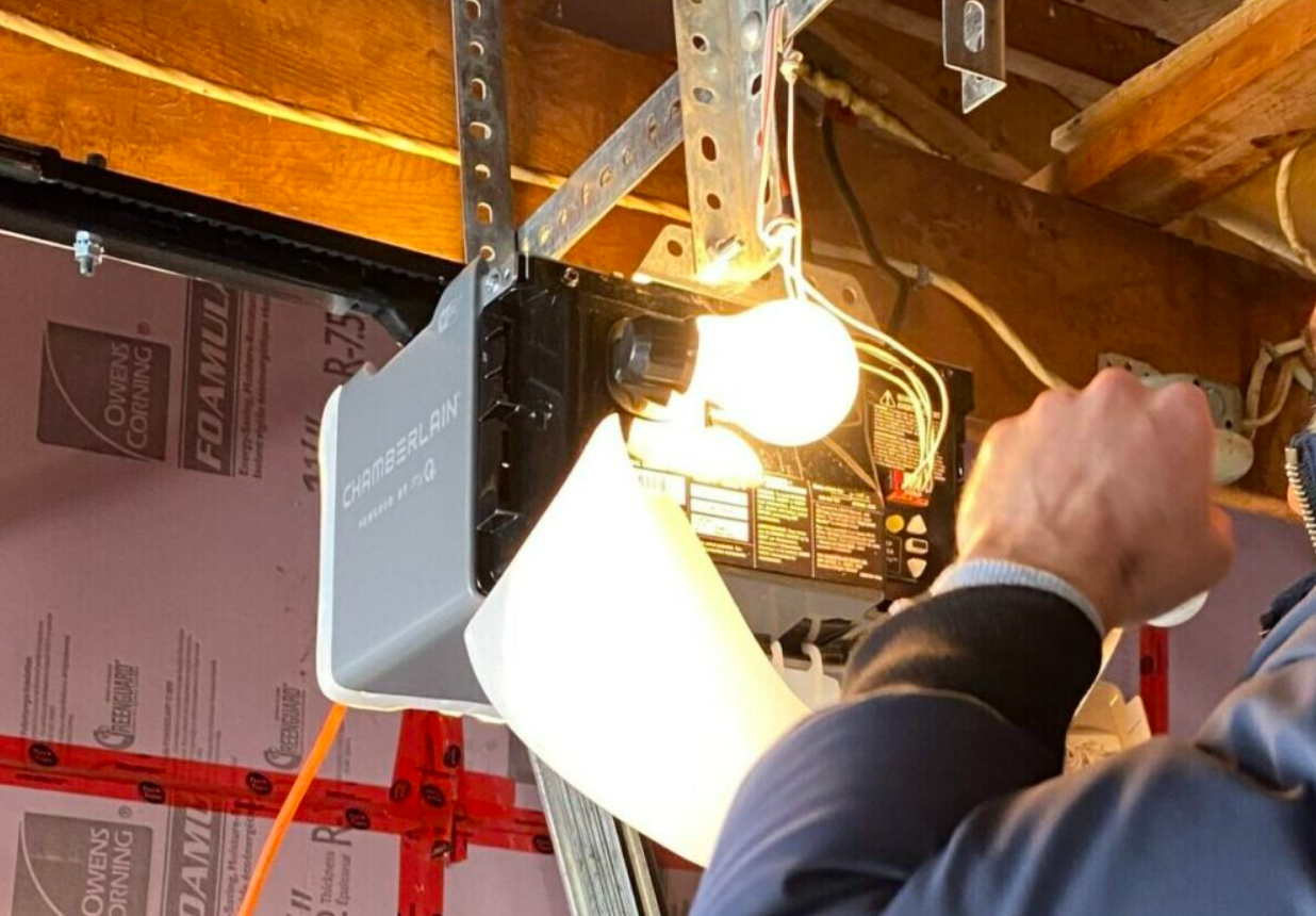 Technician performing garage door opener repair in Sun City Center, Florida.