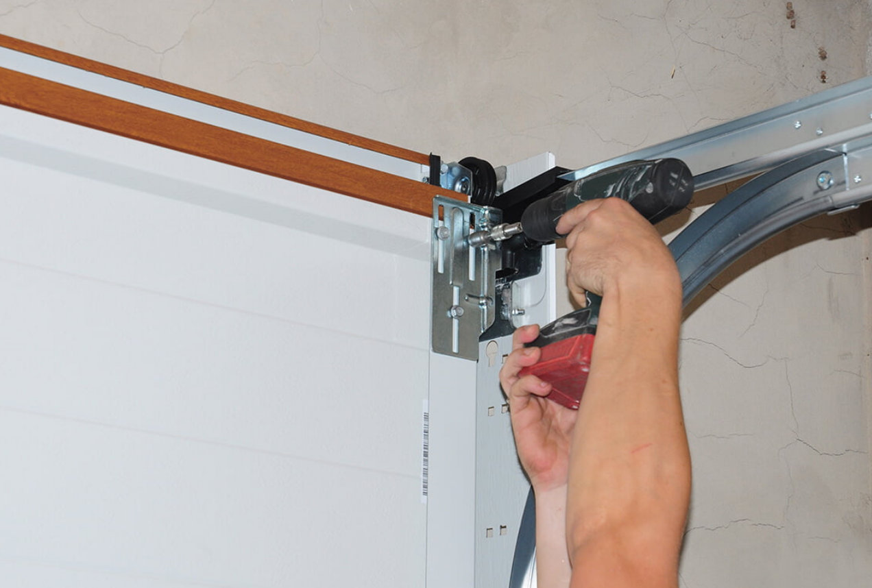 Technician performing garage door track repair in Sun City Center, Florida, ensuring smooth door operation and alignment