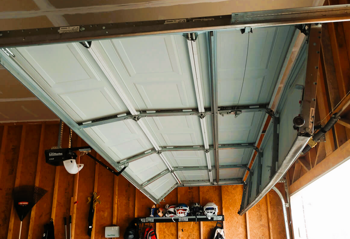 Technician performing overhead garage door repair in Sun City Center, Florida.