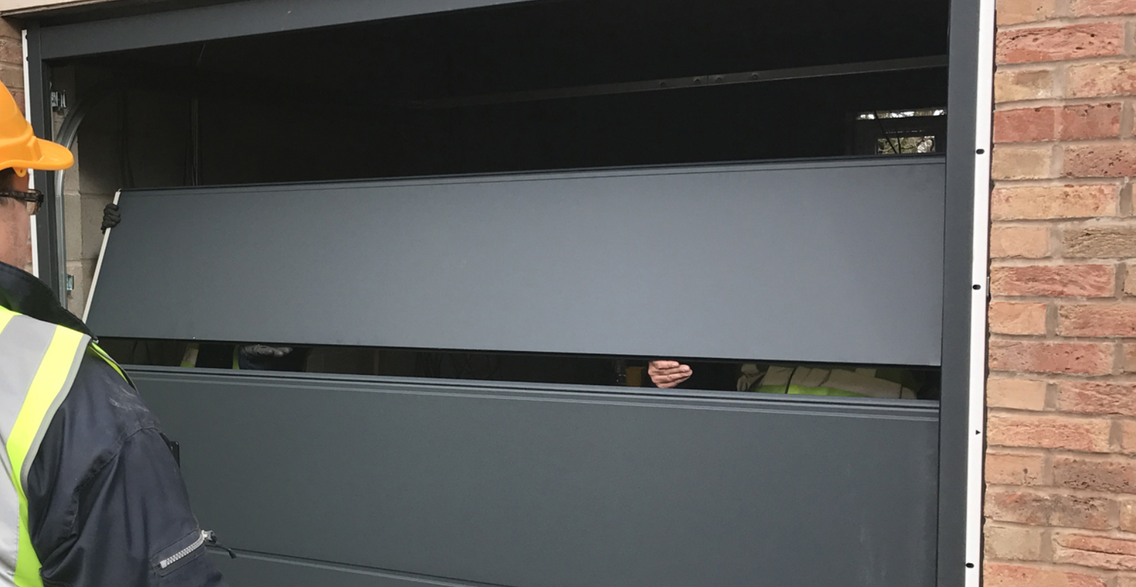 Technician performing a garage door section replacement in Sun City Center, Florida, showcasing professional tools and expertise.