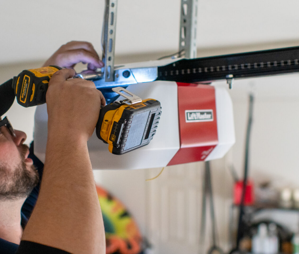 Technician installing a modern garage door opener in Sun City Center, Florida, ensuring smooth and reliable operation for residential garages.