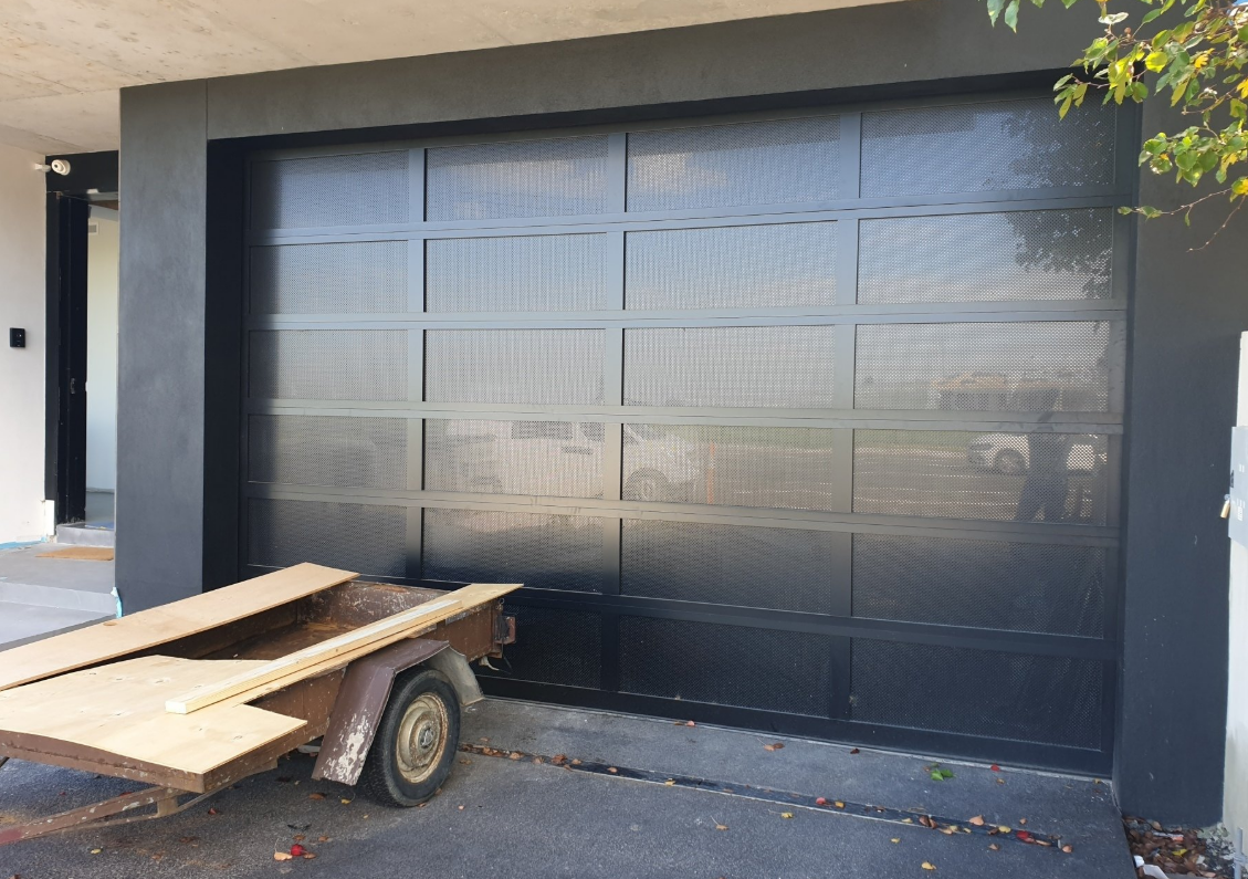 Technician performing a garage door panel repair in Sun City Center, Florida, ensuring smooth operation and durability.