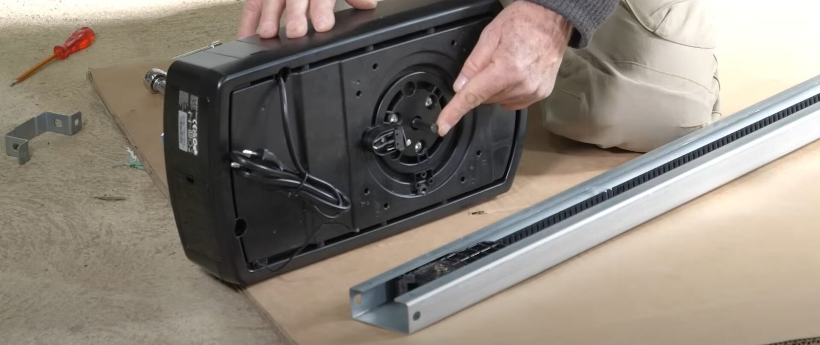 A skilled technician from Garage Door Repair Sun City Florida using professional tools to repair a garage door opener