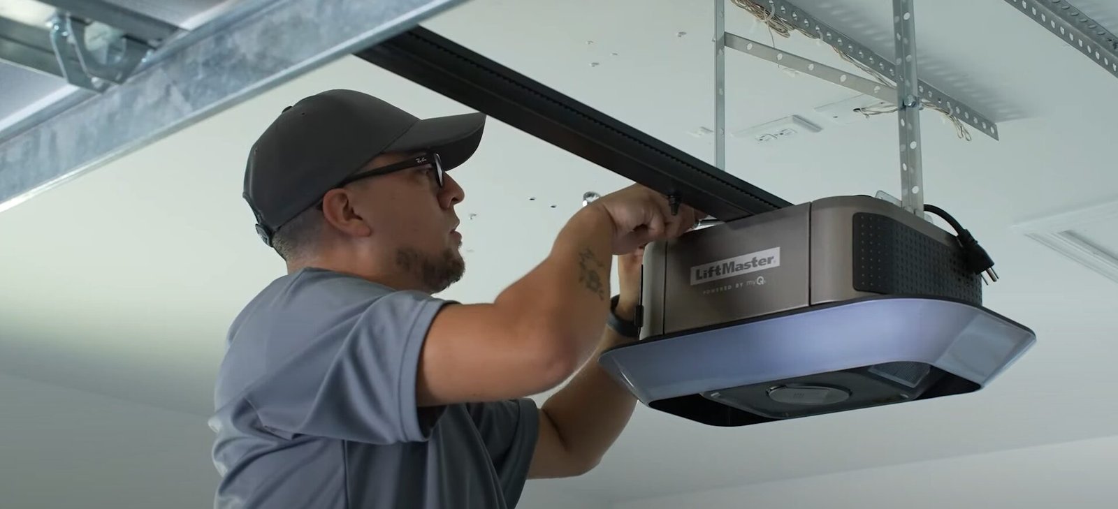 A skilled technician from Garage Door Repair Sun City Florida using professional tools to repair a garage door opener