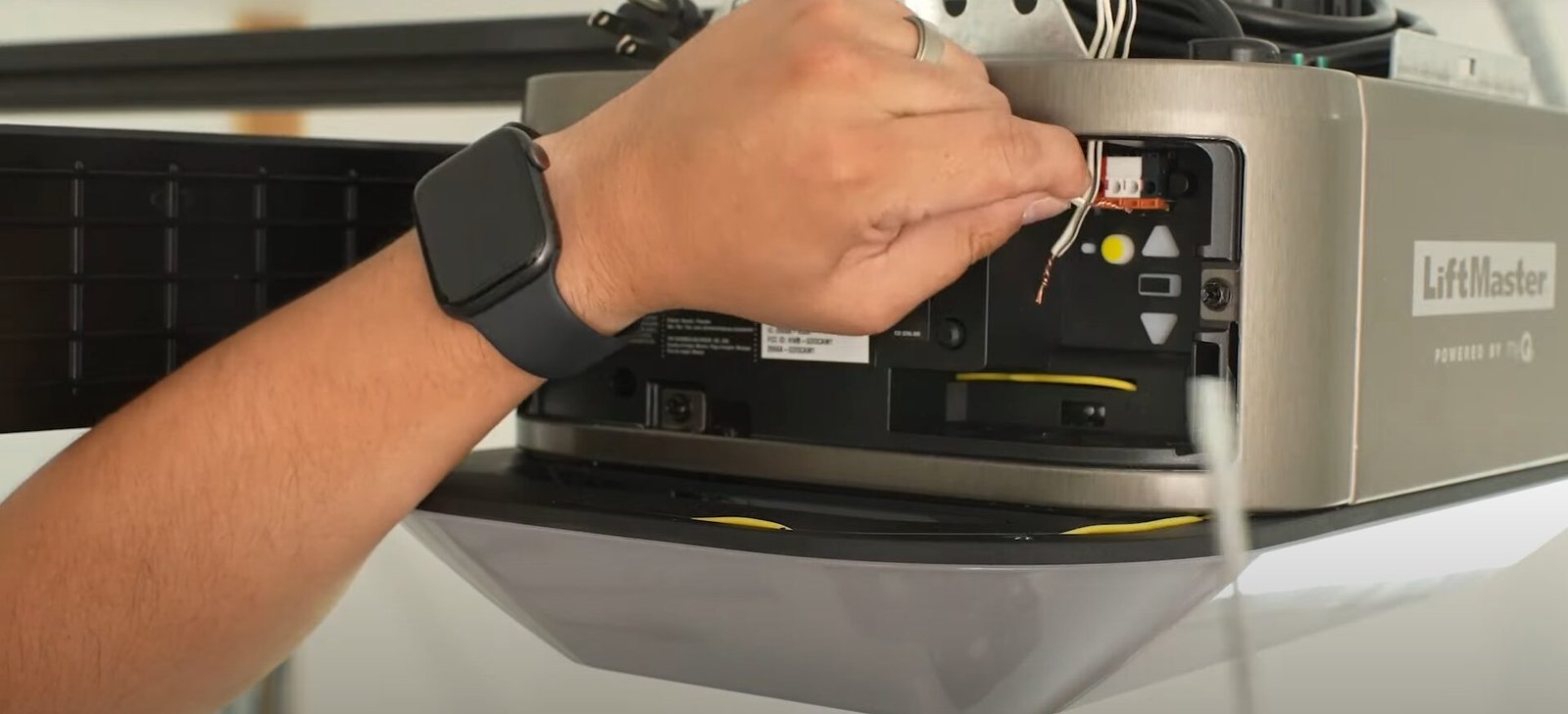 A skilled technician from Garage Door Repair Sun City Florida using professional tools to repair a garage door opener